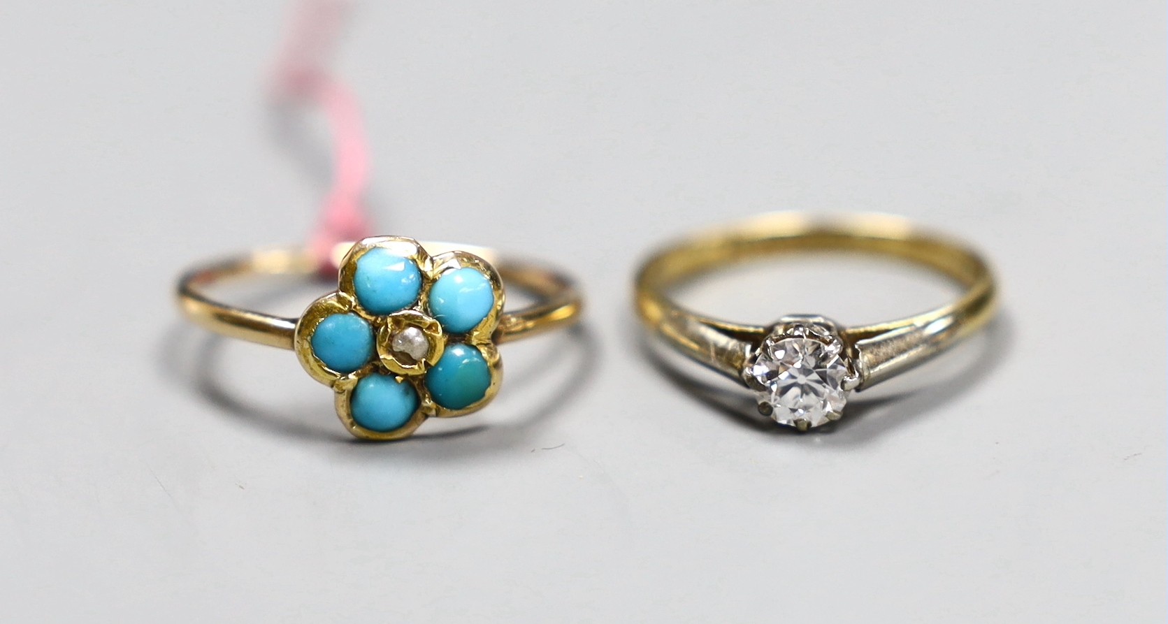 An 18ct gold and platinum solitaire diamond ring, size K, gross 2.1 grams and a turquoise set flowerhead ring, size N, gross 1.8 grams